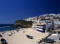 Portugal, Algarve, Carvoeiro, View over the fishing cove beach with clifftop housing beyond.