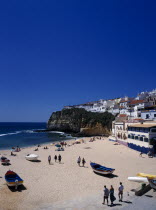 Portugal, Algarve, Carvoeiro, View over the fishing cove beach with clifftop housing beyond.