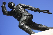 Albania, Tirane, Tirana, Statue of the Unknown Partisan, from low angle looking upwards, against blue sky.