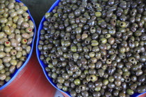 Albania, Tirane, Tirana, Bowls of olives displayed for sale  in the Avni Rustemi Market.