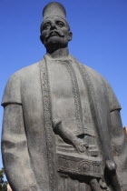 Albania, Tirane, Tirana, Three-quarter view of statue of standing male figure in traditional dress with pistol of flintlock appearance in his belt.