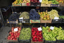 Albania, Tirane, Tirana, Grocers stall in Avni Rustemi Market with fruit and vegetable display including apples, grapes, peppers and okra.