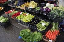 Albania, Tirane, Tirana, Display of fruit and vegetables at grocers stall in the Avni Rustemi Market including aubergines, cabbage and carrots.