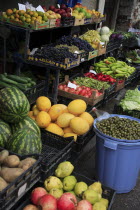 Albania, Tirane, Tirana, Grocers fruit and vegetable display in the Avni Rustemi Market including grapes, melons, peppers and olives.