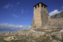 Albania, Kruja. Stone watch tower of Kruja Castle and part ruined walls.
