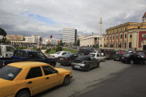 Albania, Tirane, Tirana. Congested traffic on Skanderbeg Square. Buildings include Ethem Bey Mosque, the Opera House and National History Museum.