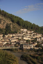 Albania, Berat, Traditional Ottoman buildings and footbridge over the river Osum.
