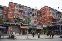 Albania, Tirane, Tirana, Colourful apartment buildings with shops below.