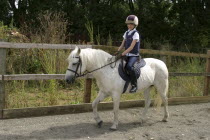 Sport, Equestrian, A young horse rider riding her pony.