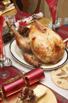 Food, Cooked, Poultry, A whole turkey ready for carving on a table laid for Christmas lunch.