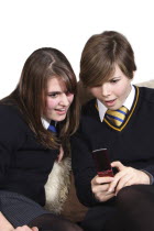 Communications, Telephone, Cell Phone, Teenage girls texting on a mobile phone.