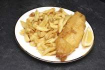 Food, Cooked, Potato, Cod, Fish and chips from a take away with a slice of lemon.