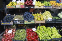 Albania, Tirane, Tirana, Display of fruit and vegetables including grapes, apples, okra and peppers in a grocer shop in the Avni Rustemi market.