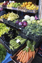 Albania, Tirane, Tirana, Display of fruit and vegetables including aubergines, carrots and cabbage at grocers in the Avni Rustemi market.