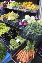 Albania, Tirane, Tirana, Display of fruit and vegetables including carrots, aubergine and cabbage at grocers shop in the Avni Rustemi market.