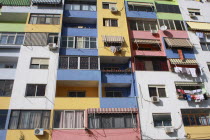 Albania, Tirane, Tirana, Part view of multi coloured apartment block exterior facade.