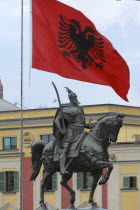 Albania, Tirane, Tirana, National flag depicting two headed eagle flying above equestrian statue of George Castriot Skanderbeg, the national hero of Albania.