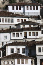 Albania, Berat, Ottoman houses in the old town with white painted exteriors and tiled roof tops.