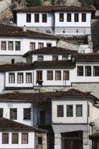 Albania, Berat, Ottoman houses in the old town with white painted exteriors and tiled roof tops.