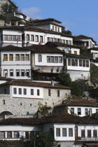 Albania, Berat, Ottoman houses in the old town with white painted exteriors and tiled roof tops.