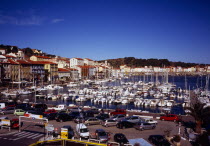 France, Languedoc Rousillon, Pyrenees Orientales, Port Vendres, Inner harbour with boats moored and cars parked on the quayside.