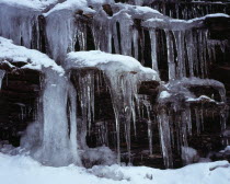 Climate, Winter, Ice, Long icicles hanging from rock face.