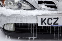 Weather, Winter, Ice, Melting snow and icicles on car fender and grill.