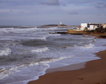 Spain, Andalucia, Cadiz, Cape Trafalgar and Los Canos de Meca village apartments overlooking beach with breaking surf.