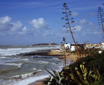Spain, Andalucia, Cadiz, Cape Trafalgar and Los Canos de Meca village apartments overlooking beach with breaking surf.
