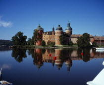 Sweden, Sodermanland, Mariefred, Gripsholm Castle beside Lake Malaren, red brick exterior with domed towers dating from sixteenth century.