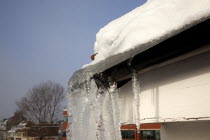 Weather, Winter, Frost, Large Icicle hanging from roof gutters.