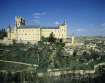 Spain, Castille Leon, Segovia, Alcazar stone fortifications on rocky crag.