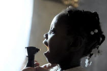 Haiti, La Gonave Island, Child being examined by medical staff provided by the Scottish Charity LemonAid to help support the people with health care.