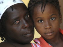 Haiti, La Gonave Island, Head and shoulders portrait of a mother and daughter.