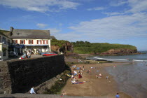 Ireland, County Waterford, Dunmore East, Seaside scence with beach and The Strand Seafood Restaurant.