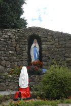 Ireland, Shrine in stone wall archway.