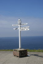 England, Cornwall, Lands End,  sign post detailing distances to John O Groats and New York.