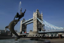 England, London, Tower Bridge with Dolphin sculture fountain in the foreground.