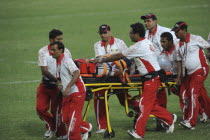 India, Delhi, 2010 Commonwealth games, Rugby game, injured player being taken off the pitch on wheeled stretcher.