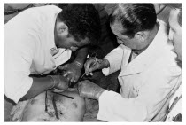 Bolivia, Santa Cruz, Vallegrande, Bolivian doctors insert formaldehyde into the body of Che Guevara through rubber tubing in the laundry room of the local Vallegrande hospital. Clearly noticeable is o...