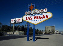 USA, Nevada, Las, Vegas, Welcome to fabulous Las Vegas sign with Wayne Newton billboard and the Mandalay hotel behind on Las Vegas Boulevard south.