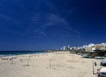 Portugal, Algarve, Praia da Rocha, view along beach with clifftop hotels.