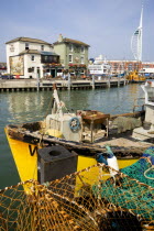 England, Hampshire, Portsmouth, The Camber in Old Portsmouth showing the Spinnaker Tower beyond the Bridge Tavern with a mural by Thomas Rowlanson of his cartoon entitled Portsmouth Point with fishing...