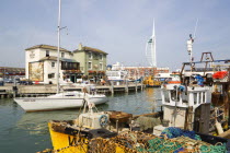 England, Hampshire, Portsmouth, The Camber in Old Portsmouth showing the Spinnaker Tower beyond the Bridge Tavern with a mural by Thomas Rowlanson of his cartoon entitled Portsmouth Point with fishing...