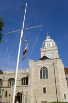 ENGLAND, Hampshire, Portsmouth, The Anglican Cathedral Church of St Thomas of Canterbury started in the 12th Century consecrated in 1927 and completed in 1980 with a flagpole in foreground.