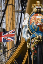 ENGLAND, Hampshire, Portsmouth, Bow and rigging of Admiral Lord Nelson's flagship HMS Victory showing the ship's figurehead with Royal Crest and Union Flag in the Historic Naval Dockyard.