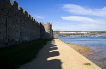 England, Hampshire, Portsmouth, Portchester Castle Norman 12th Century flint walls rebuilt on the site of the Roman 3rd Century Saxon Shore Fort.