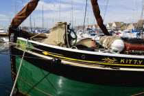 England, Hampshire, Portsmouth, Port Solent Sailing barge SB Kitty moored in the marina with housing beyond.