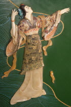 China, Beijing, Painted jade carving of a Chinese woman, on a piece of furniture.