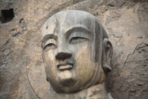 China, Henan Province, Luoyang, Carved Buddha statue in the Fengxian Temple, Tang Dynasty Longmen Grottoes and Cave.